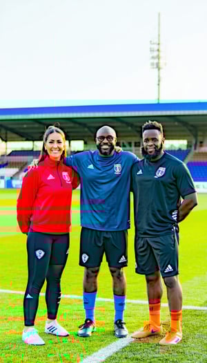 image of soccer coaches representing diversity with mixed gender and race on a football field-1